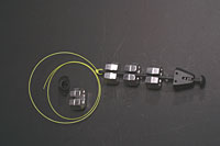 The main component is a central stem onto which is mounted a spring