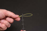 Thread the loop through the eye at the top of the stem