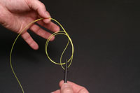 Thread the end of the stem through the loop then tighten.