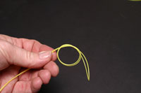 Tie an overhand knot at the top of the loop